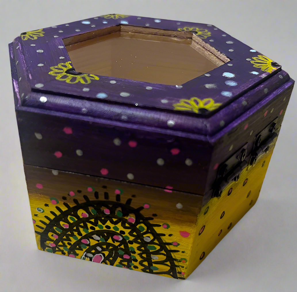 A hand painted yellow purple wooden box with glass lid