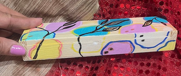 A hand painted wooden sleek box