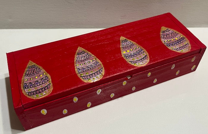 A sleek red hand painted wooden box