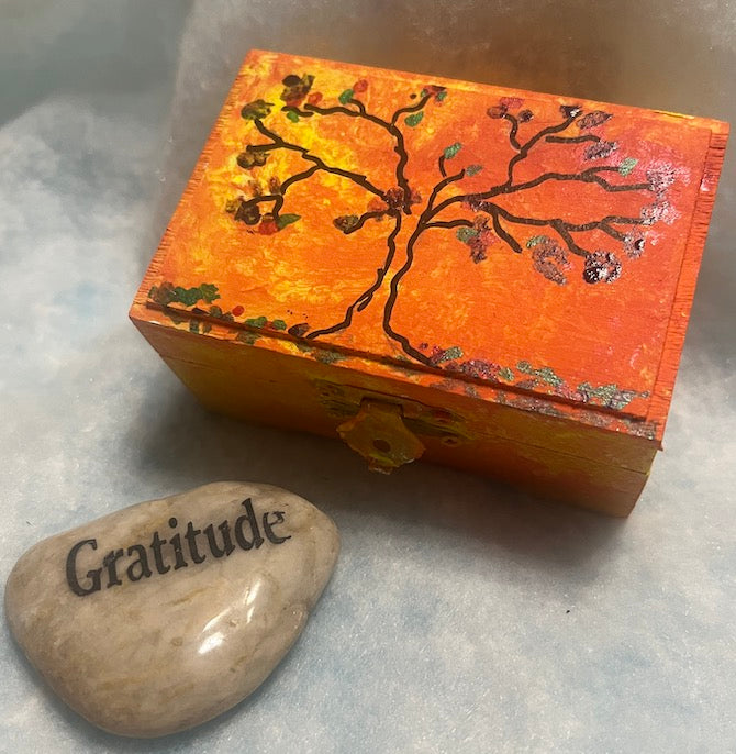 An orange hand painted  tree wooden box