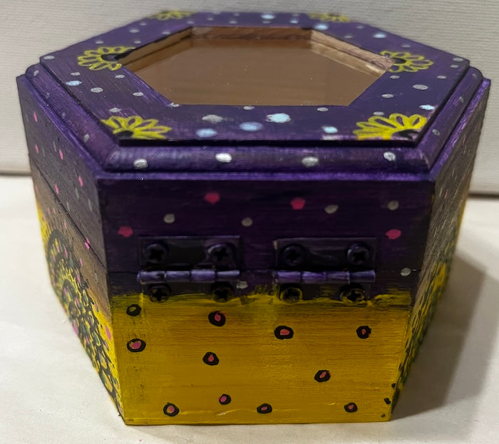 A hand painted yellow purple wooden box with glass lid