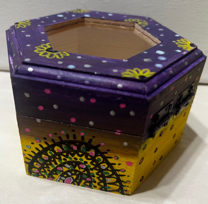A hand painted yellow purple wooden box with glass lid