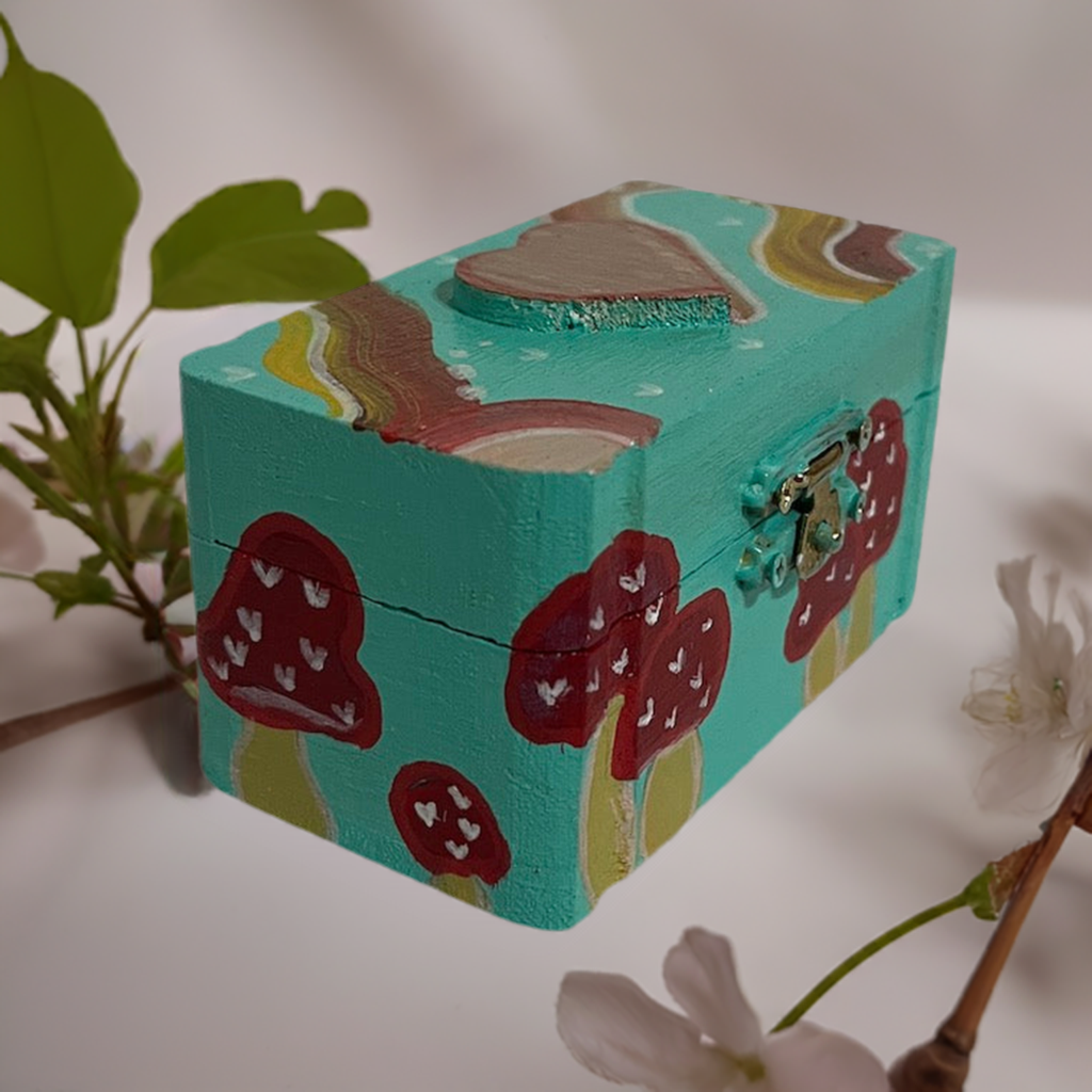 A small hand painted mushroom box with matching earrings.