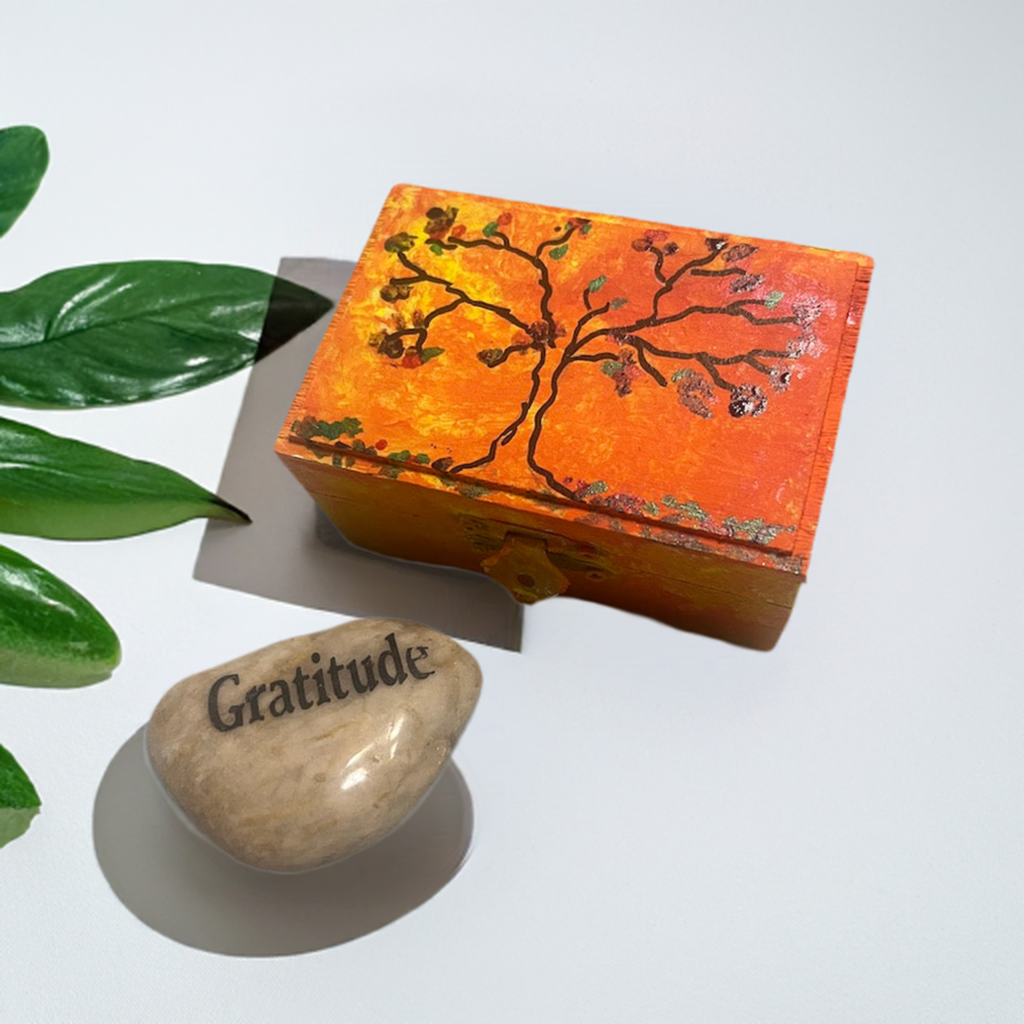 An orange hand painted  tree wooden box