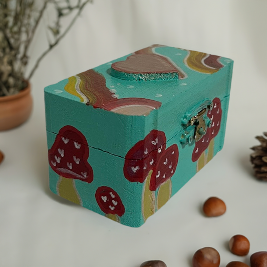 A small hand painted mushroom box with matching earrings.
