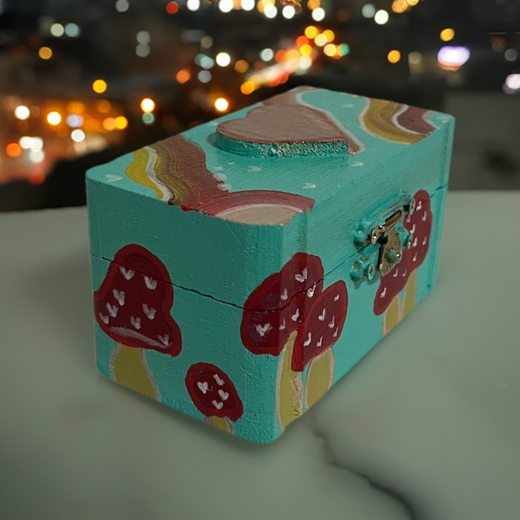 A small hand painted mushroom box with matching earrings.