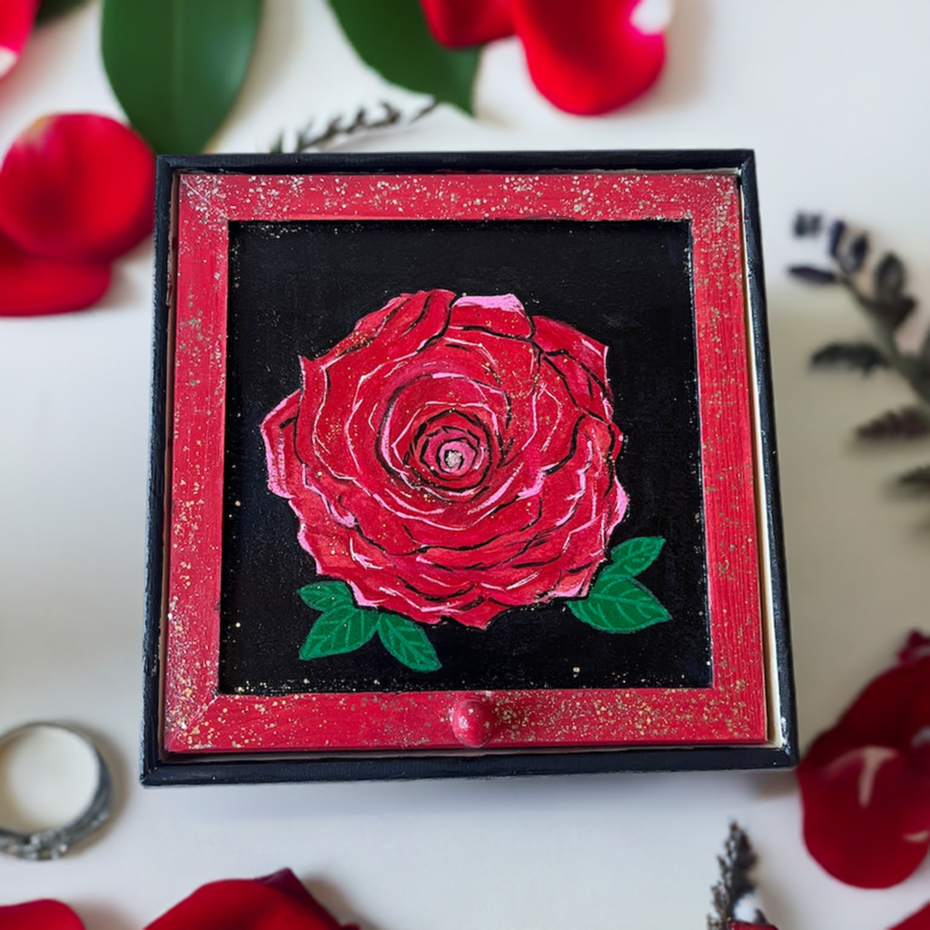 A hand painted rose jewelry box.