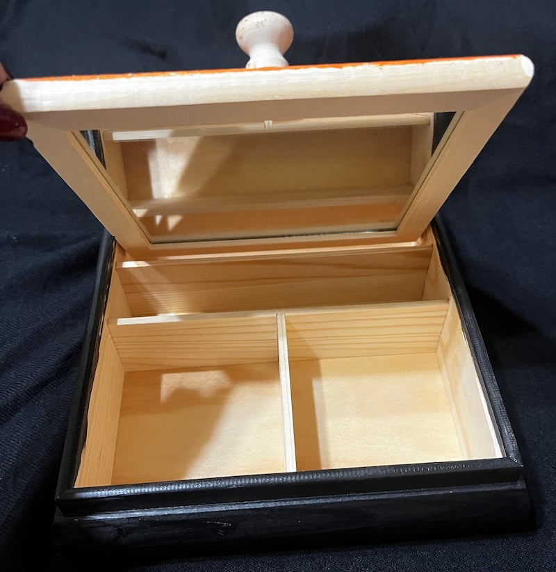 A hand painted rose jewelry box.