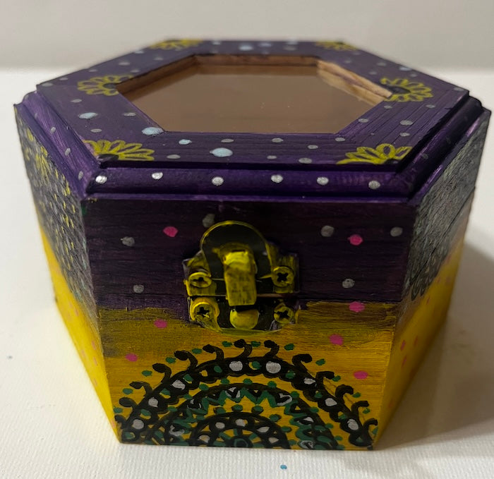 A hand painted yellow purple wooden box with glass lid