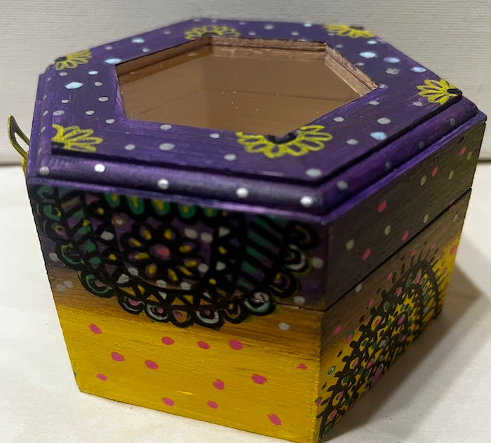 A hand painted yellow purple wooden box with glass lid