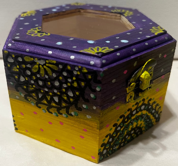 A hand painted yellow purple wooden box with glass lid