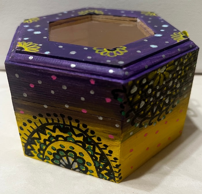 A hand painted yellow purple wooden box with glass lid
