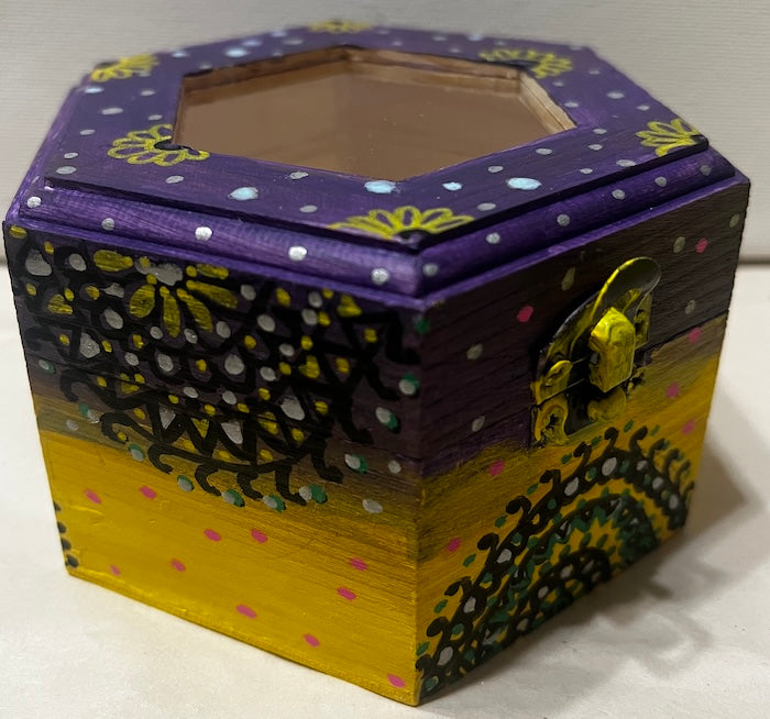 A hand painted yellow purple wooden box with glass lid