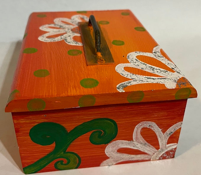 An orange hand painted wooden box with a removable lid