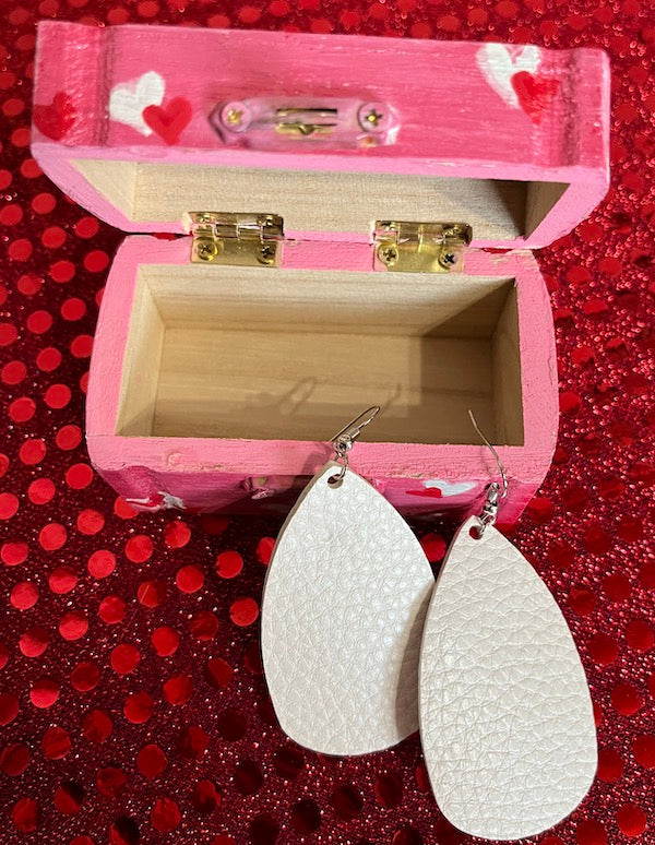 A pink heart box with matching earrings