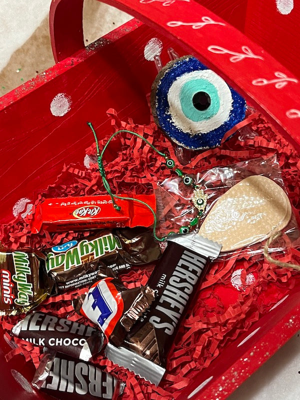 A red hand painted wooden basket