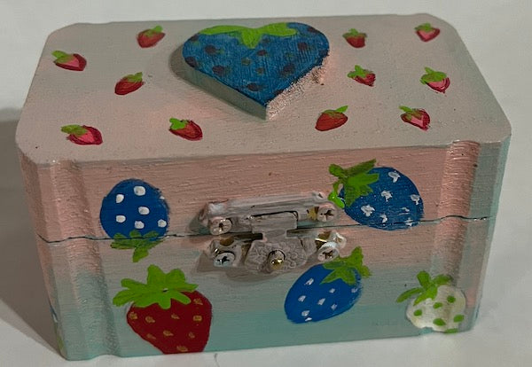A strawberry painted box with heart top