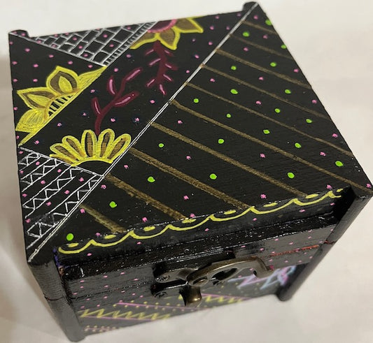 A black hand painted floral and abstract wood box