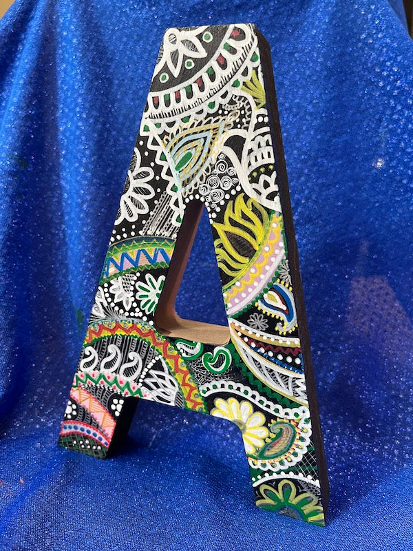 A wooden hand painted letter