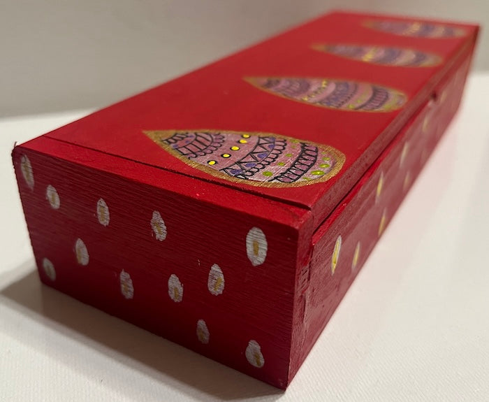 A sleek red hand painted wooden box