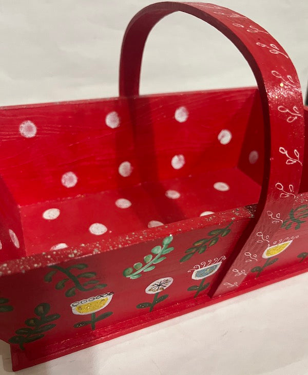 A red hand painted floral  wood basket