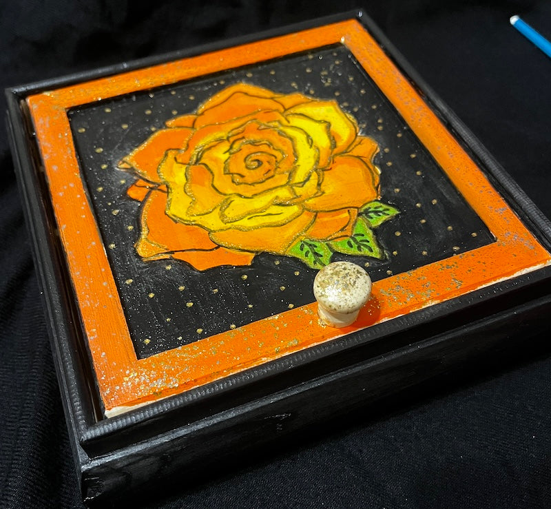 A hand painted red rose jewelry box.