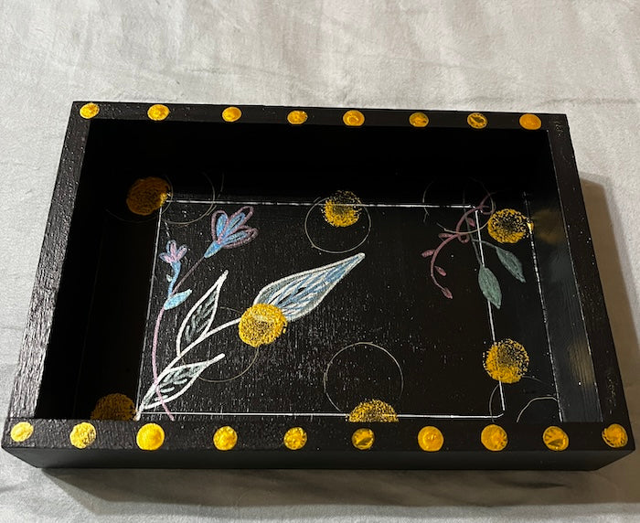 a hand painted black tray