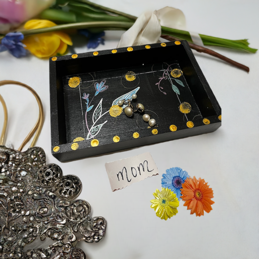 a black hand painted wooden tray