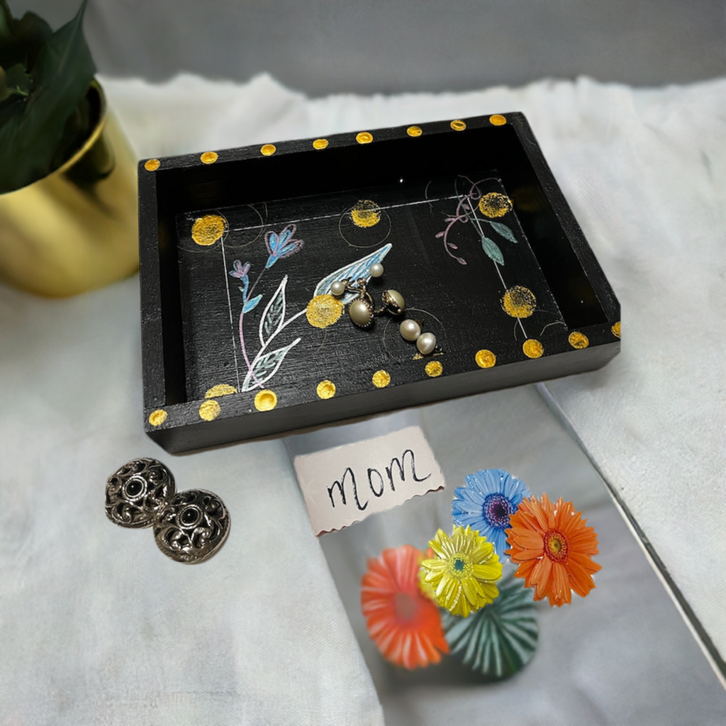 A small hand painted wooden trinket tray