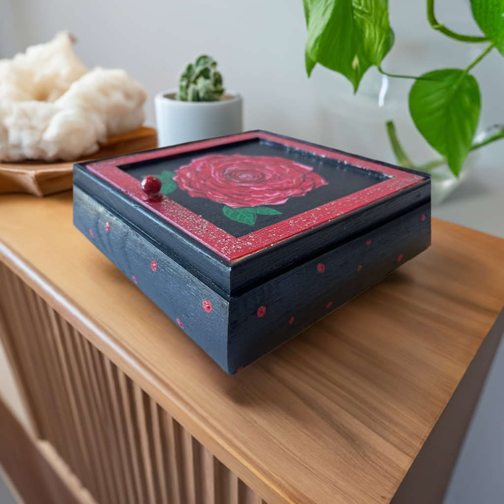 A hand painted red rose jewelry box.