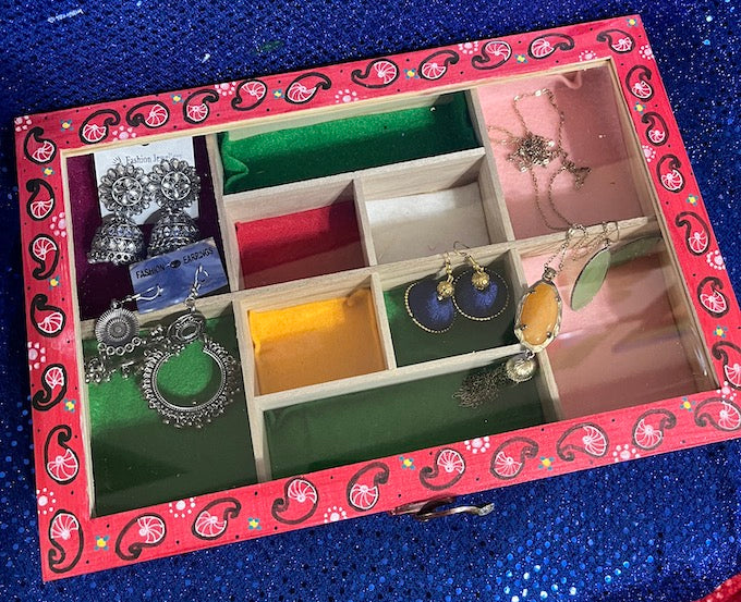 a glass top red jewelry box