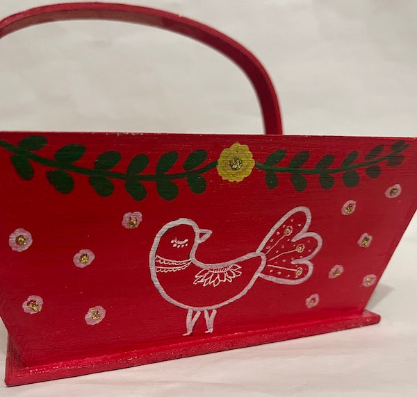 A red hand painted floral  wood basket