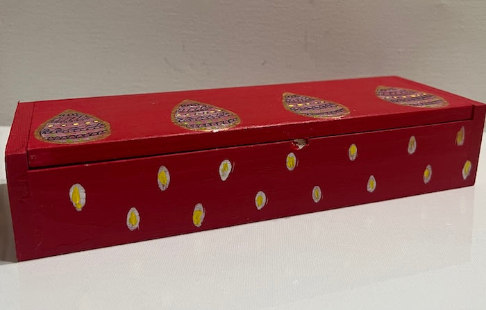 A sleek red hand painted wooden box