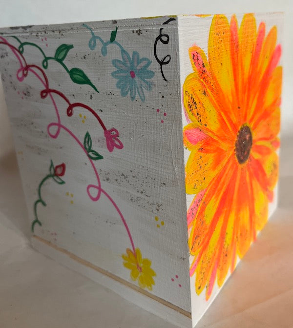 A hand painted wood tissue box cover