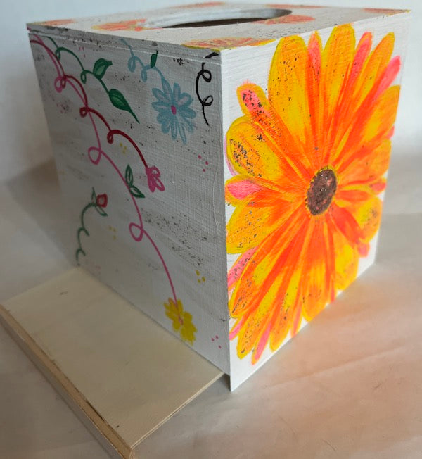 An opening at the bottom hand painted wood tissue box