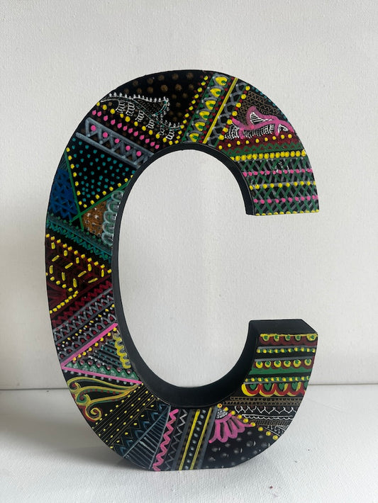 a hand painted wooden letter C
