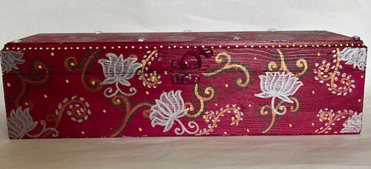 A magenta hand painted long wooden box
