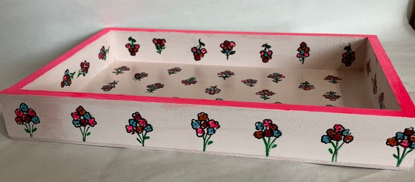 A hand painted floral pink wood tray