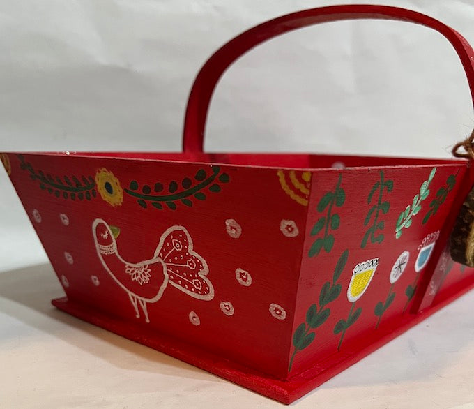 A peacock art on the sides of a red basket