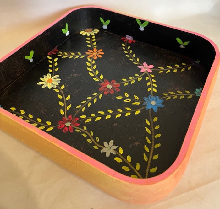 A black and colorful hand painted floral tray.