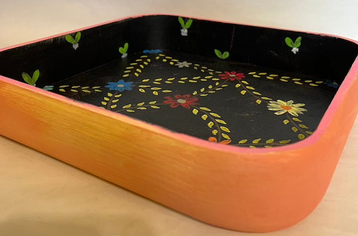 A black and colorful hand painted tray