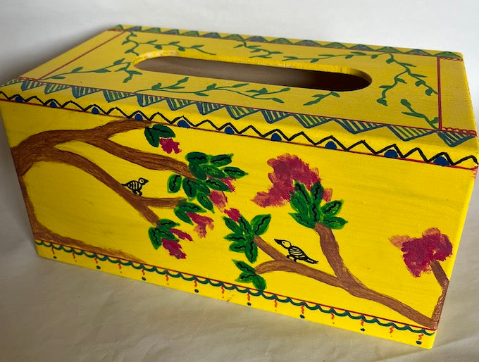 A yellow hand painted tissue box cover