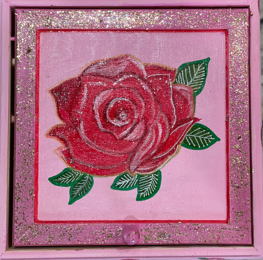 A pink hand painted rose glitter and shimmer jewelry box