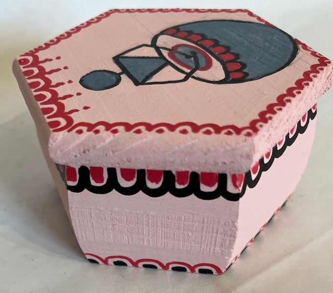 A hand painted small hexagon pink gift box