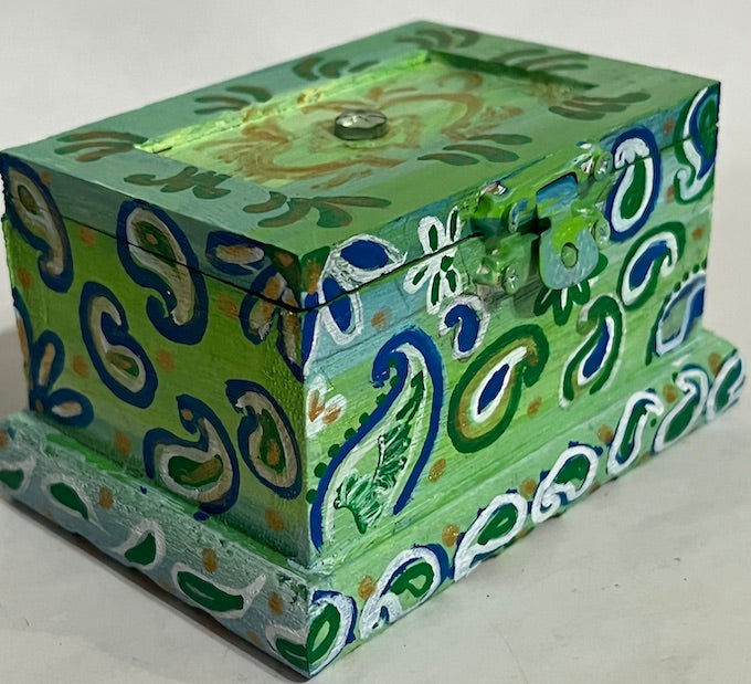 A jewel top hand painted green wooden box with lid.