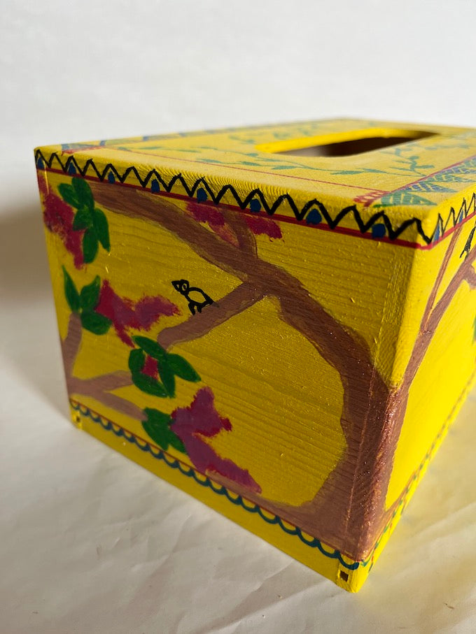 A yellow hand painted wooden tissue box cover