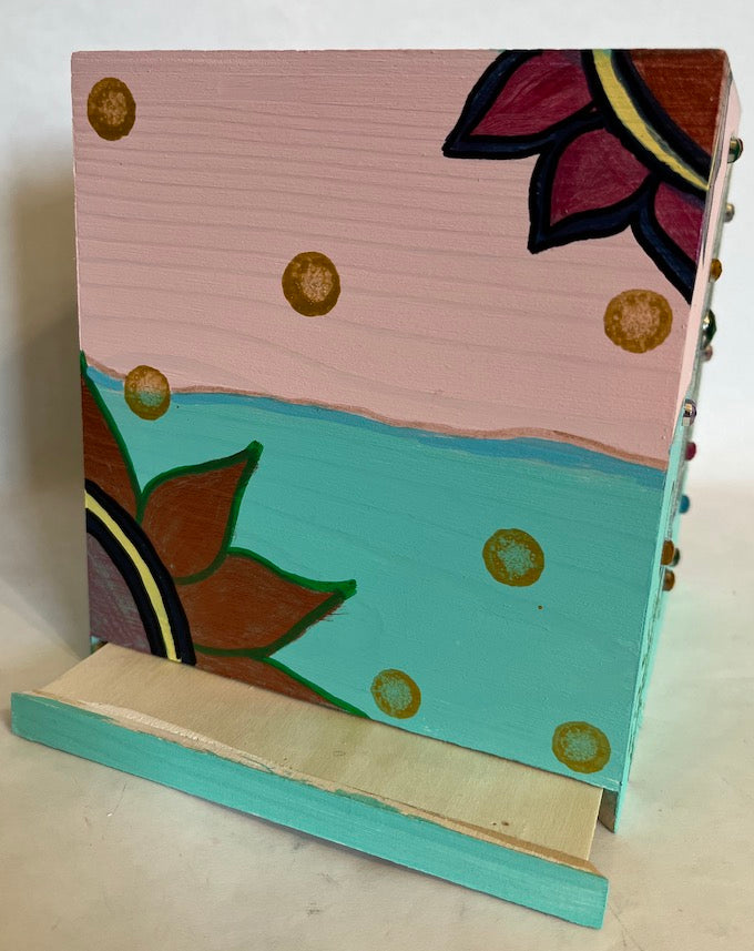 A hand painted two shade pink and aqua wooden tissue box cover