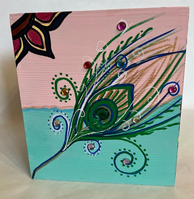 A peacock feather art and jeweled two shaded wooden tissue box cover