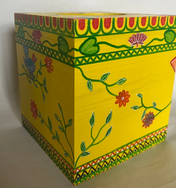 A yellow hand painted bright yellow, colorful wooden tissue box cover