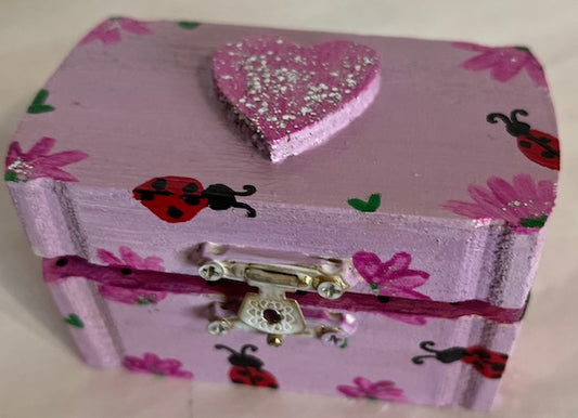 A small purple hand painted lady bug floral box
